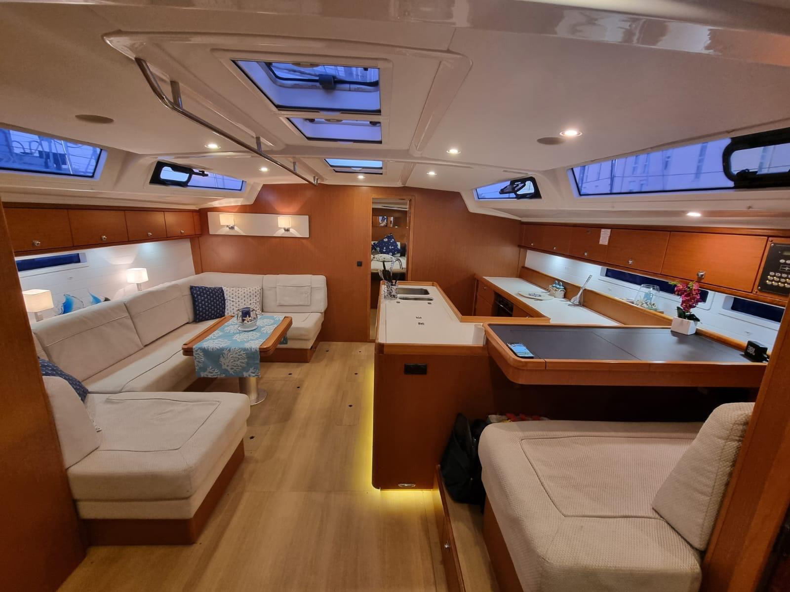 Bavaria 56 interior saloon with timber finishes &mdash; luxury sailing charter